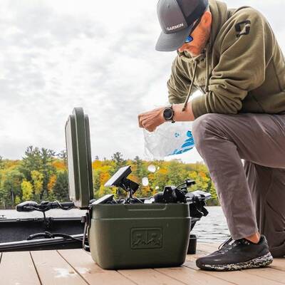 Man filling Rugged Road Cooler with ice